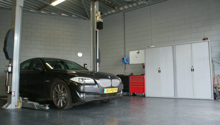 Onze werkplaats met auto op de brug